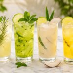 Négy különböző limonádé változat magas pohárban egymás mellett fehér márványon, brazil, egyiptomi, kolumbiai és ananászos verzió